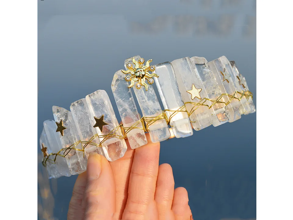 A clear crystal crown headband with sun and star charms.