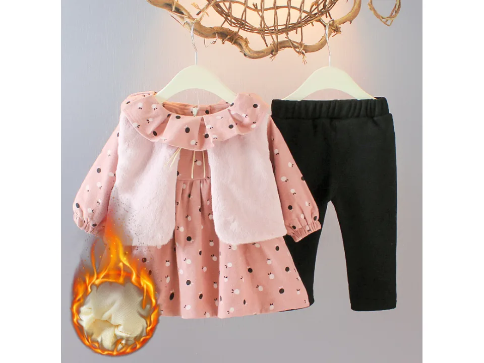 Pink baby girl outfit set with plush vest, long sleeve dress, and black pants, showing warm lining detail.