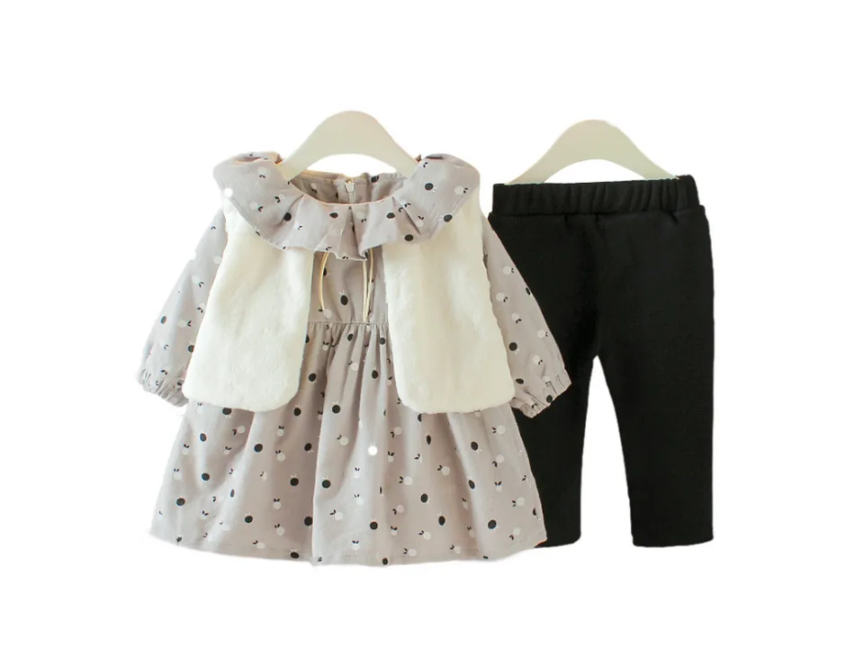 Grey baby girl outfit set with plush vest, long sleeve dress, and black pants on hangers.