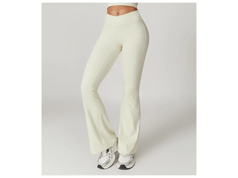 Front view of cream-colored high-waisted flare yoga pants on a model.