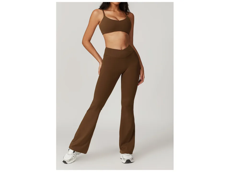 Model wearing brown high-waisted flare yoga pants with a crossover waistband.