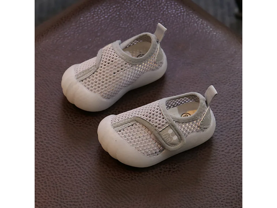 Pair of grey breathable mesh baby sneakers with velcro closure.