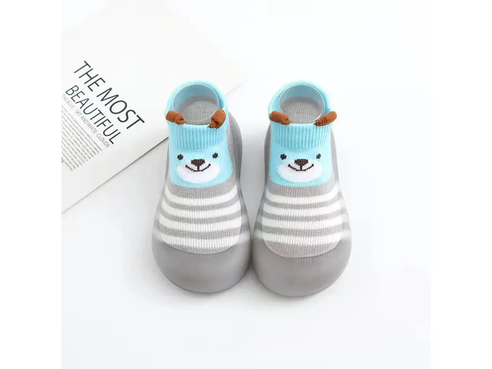A pair of blue toddler sock shoes with a bear face design.