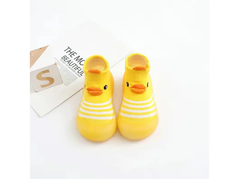 A pair of yellow toddler sock shoes with a duck face design.
