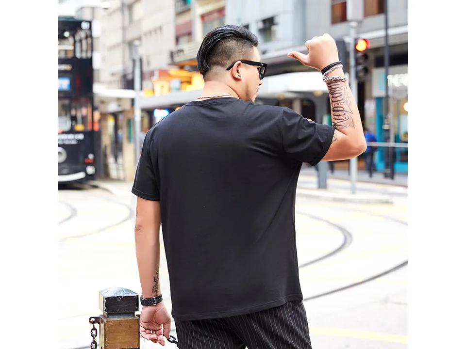 A man seen from behind wearing the black t-shirt.