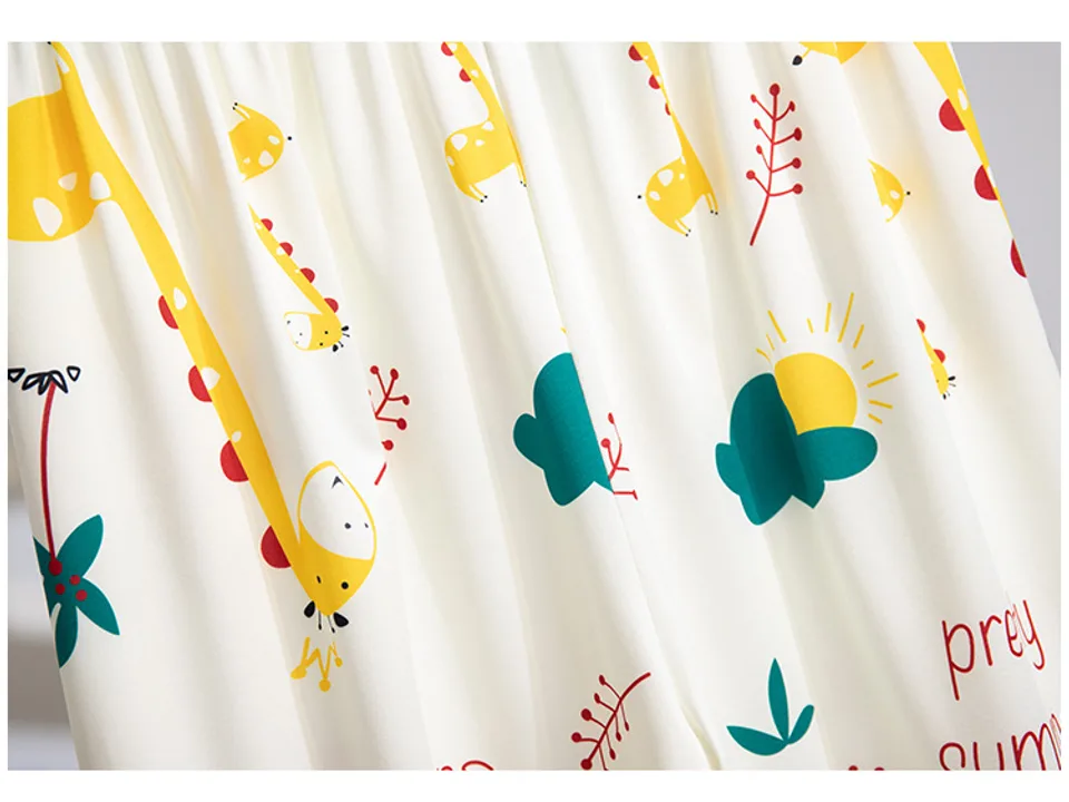 Close-up of the fabric showing the giraffe, sun, and cloud pattern.