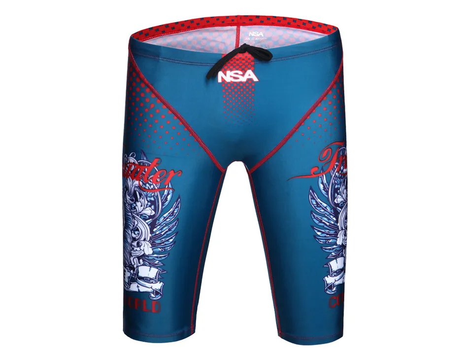 Front view of blue swimming trunks with red polka dots and graphic print.