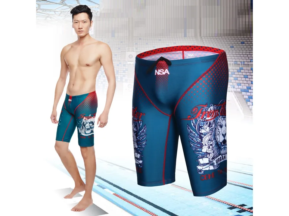 Model wearing the blue swimming trunks with graphic print.