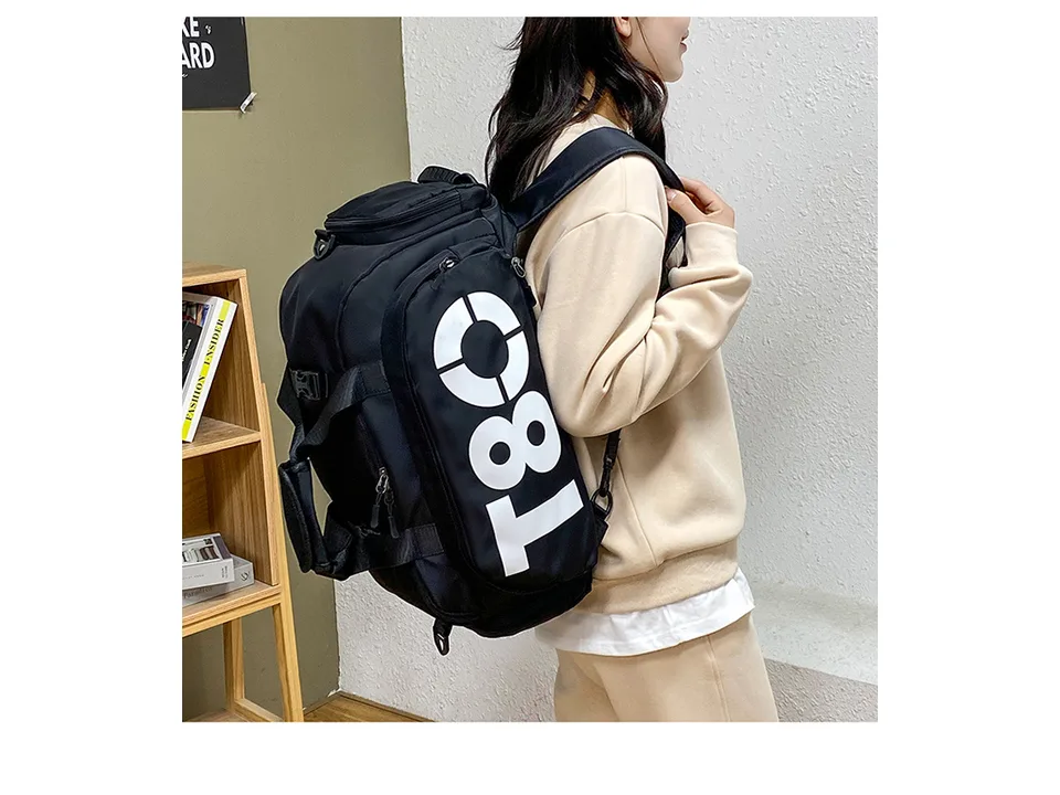 A person wearing the black gym bag as a backpack.