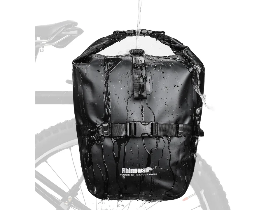 Black waterproof bicycle pannier bag being sprayed with water