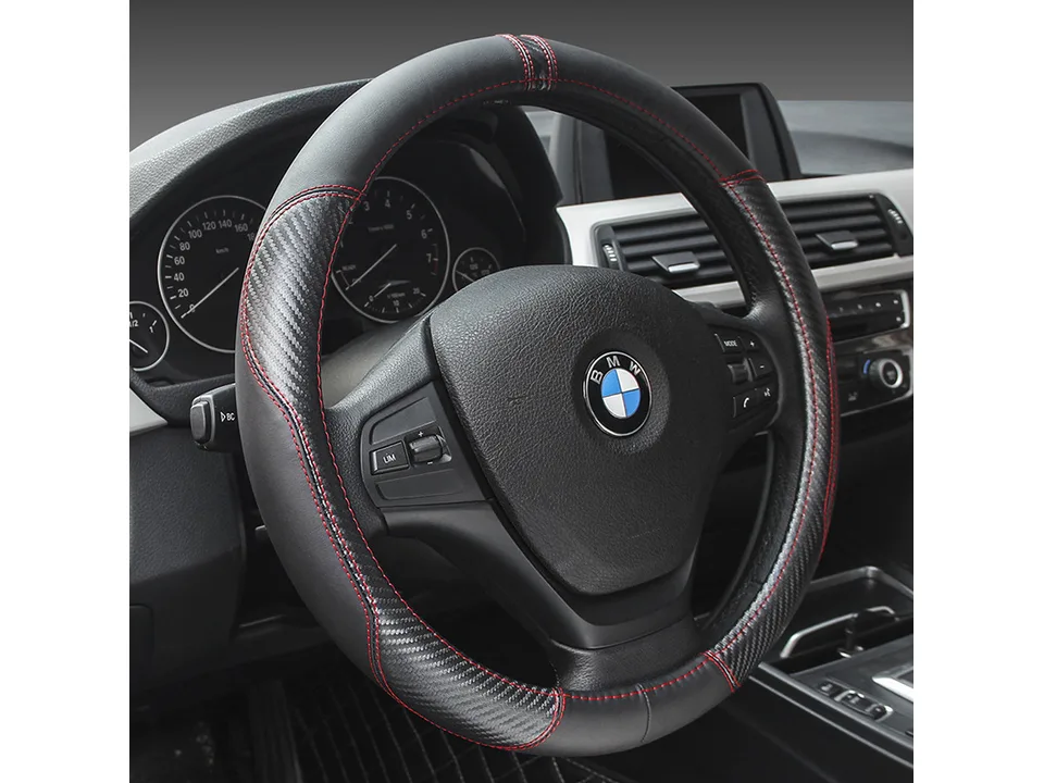 Black leather steering wheel cover with red stitching installed on a BMW steering wheel.