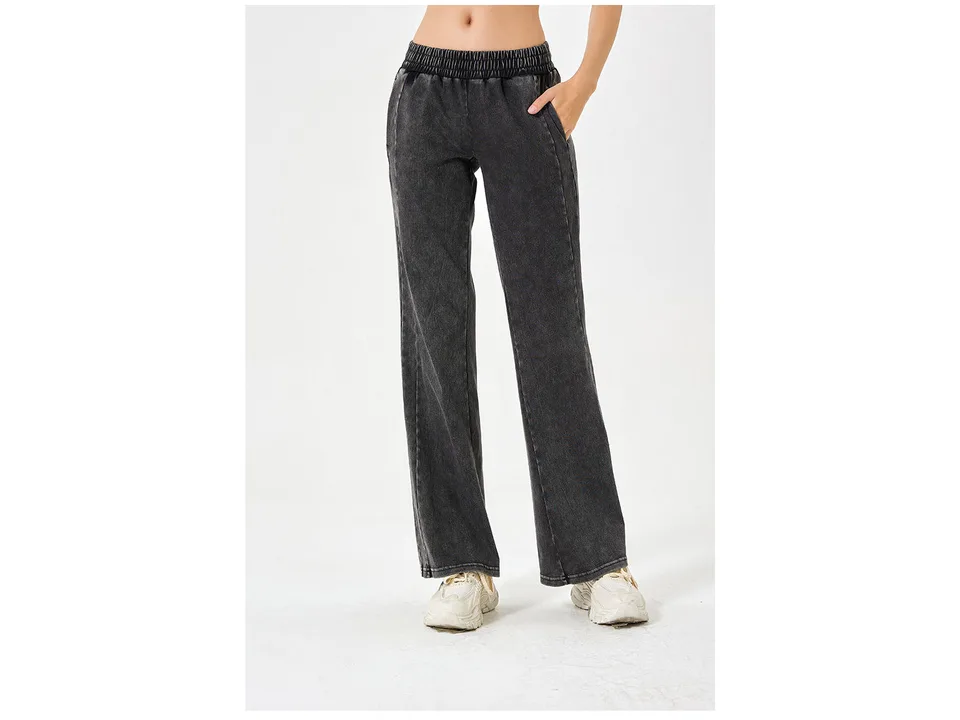 Front view of a woman wearing dark grey loose fit denim jeans.