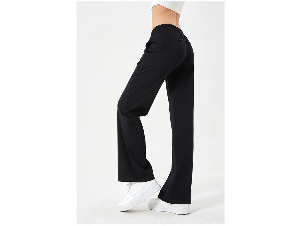 Back view of a woman wearing black loose fit denim jeans.