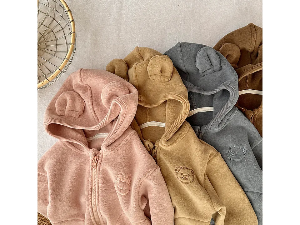 A collection of kids' fleece zip-up hoodies in pink, tan, grey, and brown, all featuring bear-ear hoods.