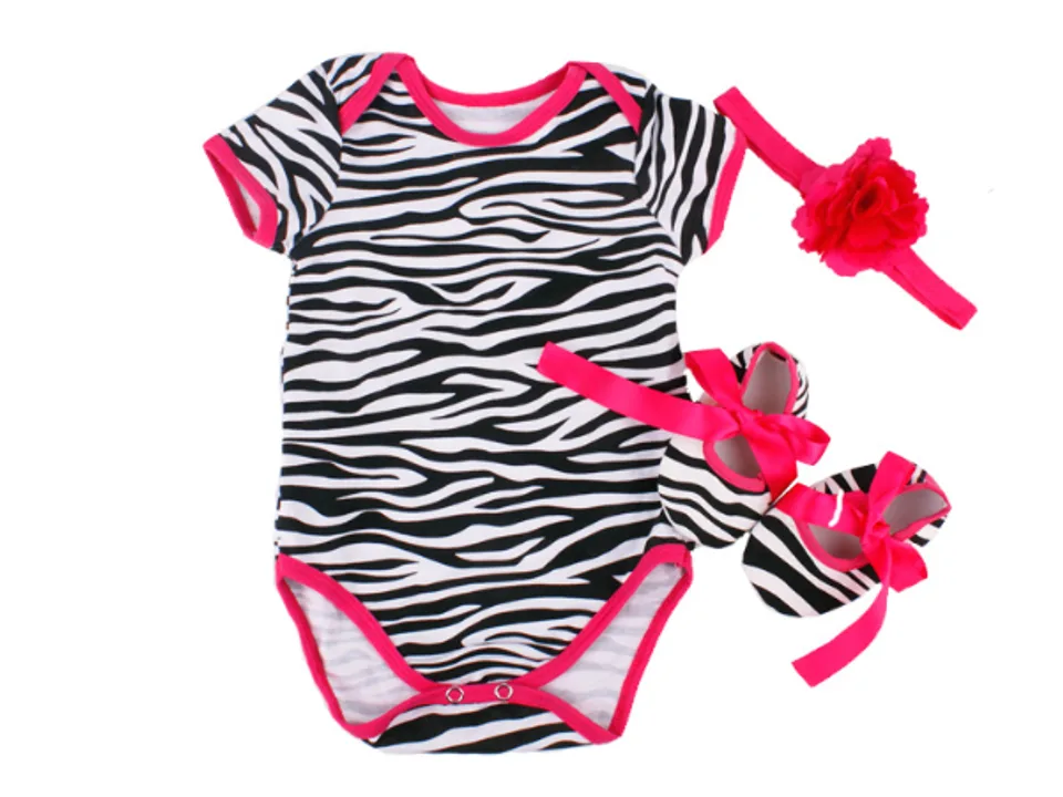 Baby romper set with zebra print, matching headband, and shoes.