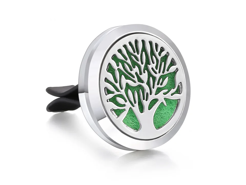 Stainless steel car air freshener vent clip with a tree of life design and green insert.