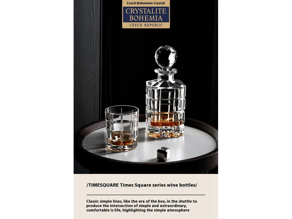Crystal whiskey decanter and glass set on a round table.