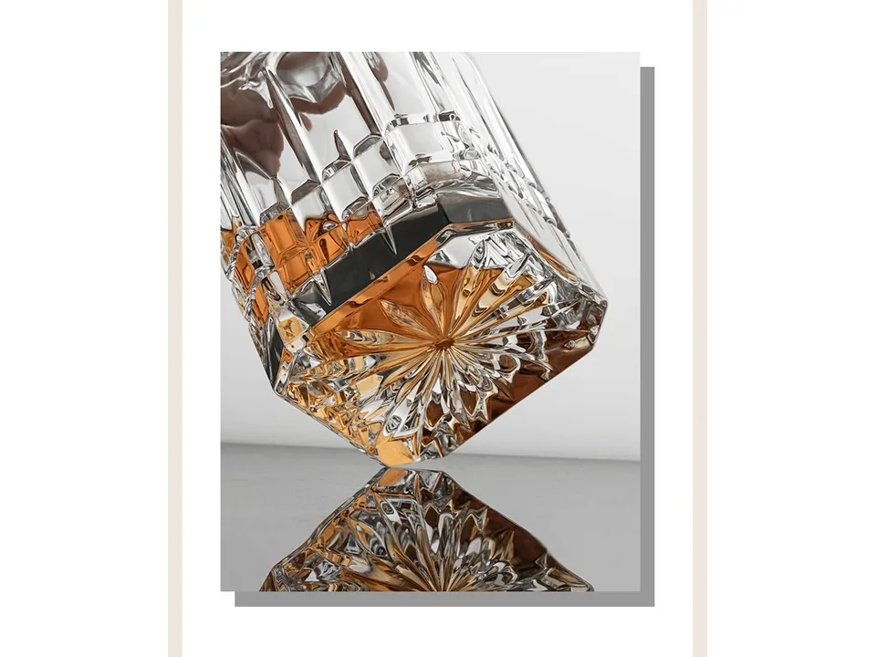 Close-up of the crystal decanter base showing the intricate star-cut pattern.