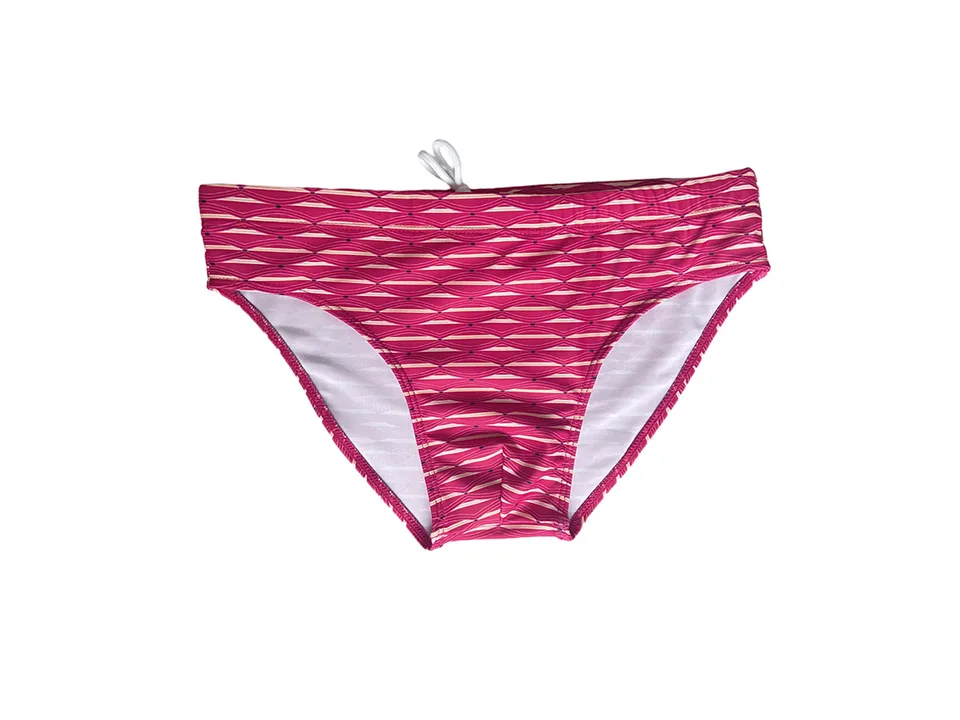 Red patterned swim briefs with a white drawstring, isolated on white background.