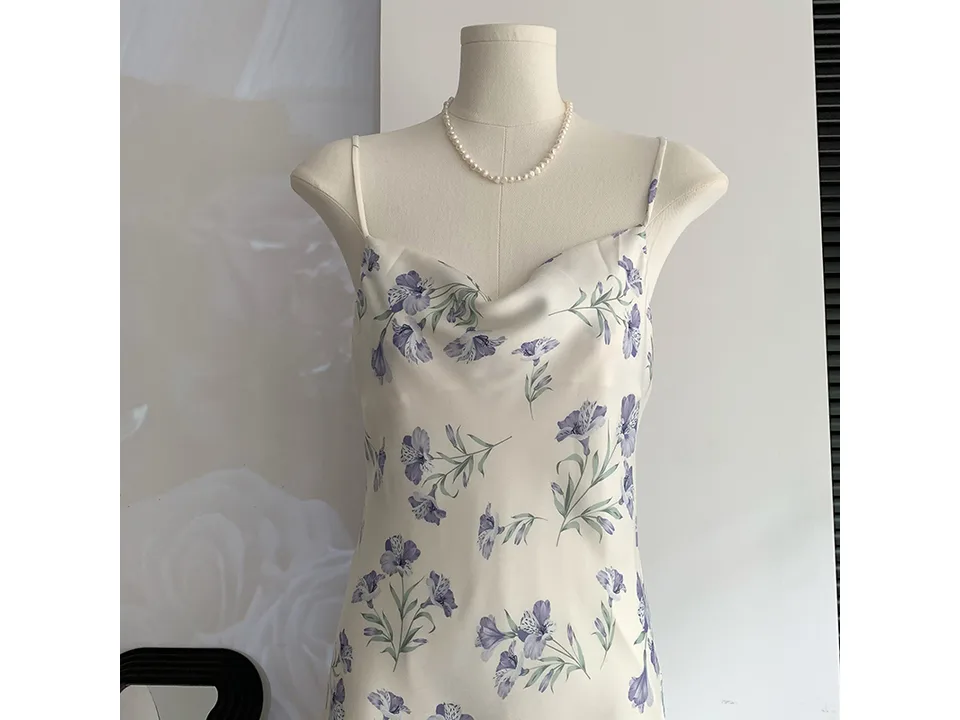 Close-up of the cowl neckline and floral pattern of the dress.