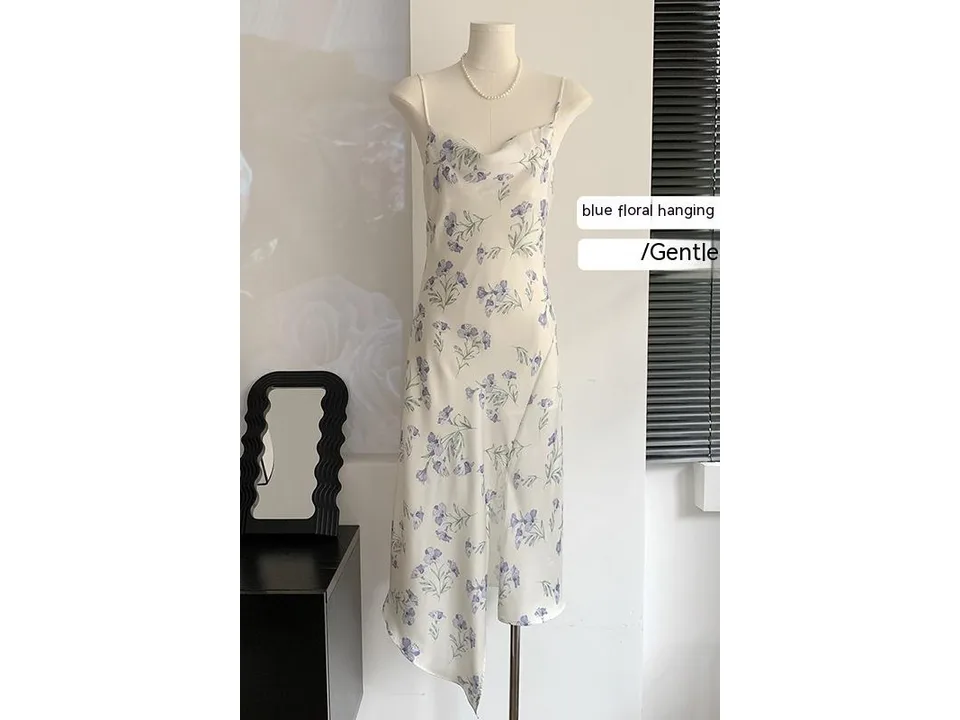 A floral midi slip dress with a cowl neck on a mannequin.