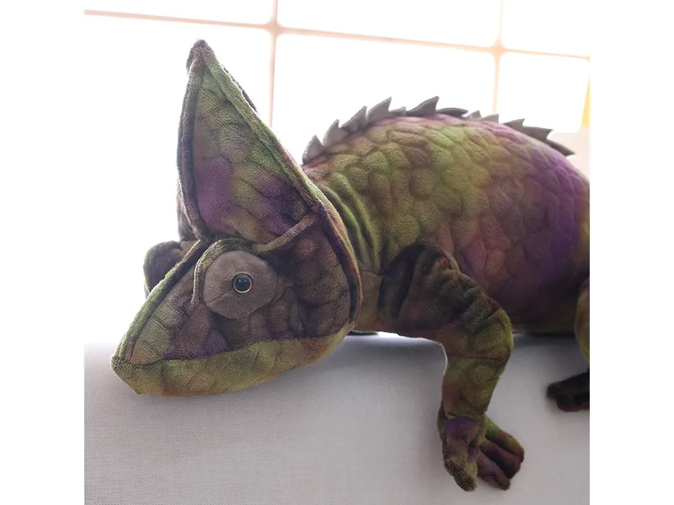 Close-up of a green and purple plush chameleon toy.