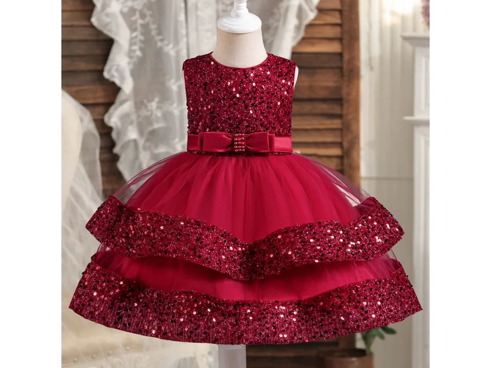 Front view of a red princess dress with a sequin bodice and tulle skirt on a mannequin.