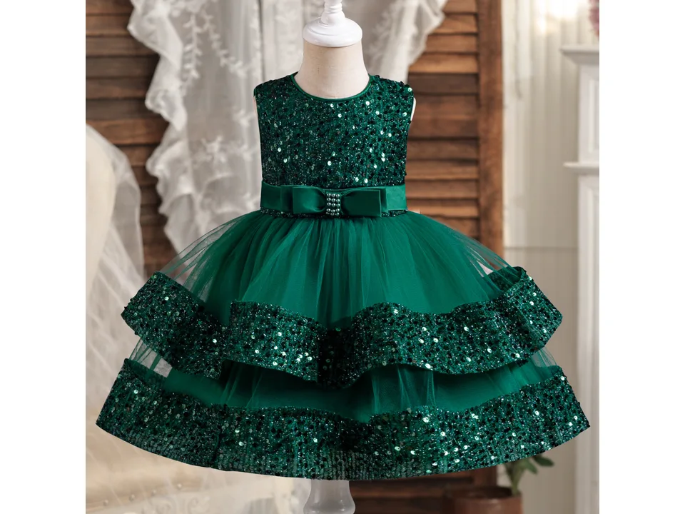 Front view of a green princess dress with a sequin bodice and tulle skirt on a mannequin.