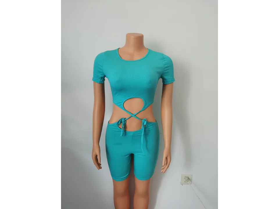 Teal ribbed knit cutout jumpsuit on a mannequin