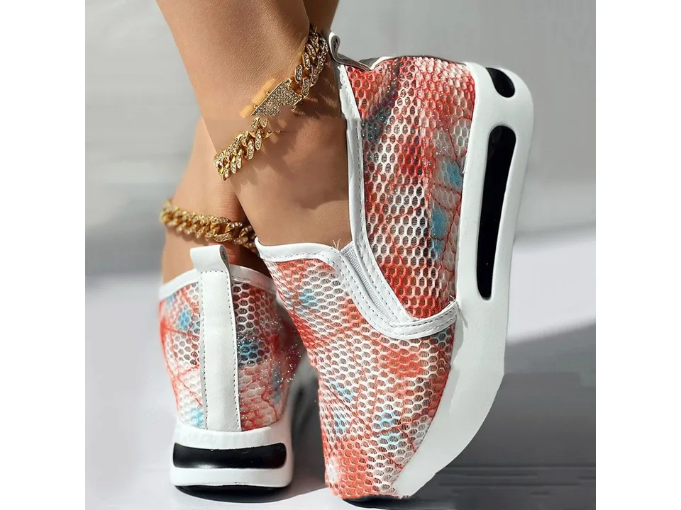 A pair of orange and blue mesh slip-on shoes with white platform soles shown from the side.