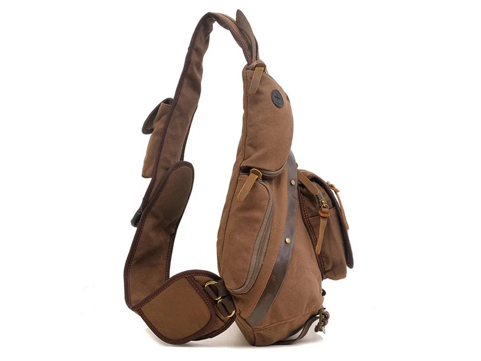 Side view of the brown canvas sling backpack showing the strap