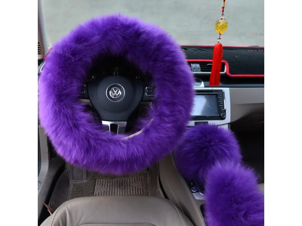 Purple plush steering wheel cover and matching gear shift cover installed in a car.