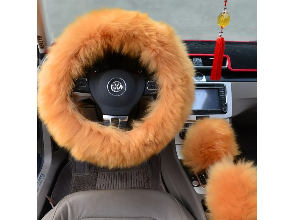 Orange plush steering wheel cover and matching gear shift cover installed in a car.