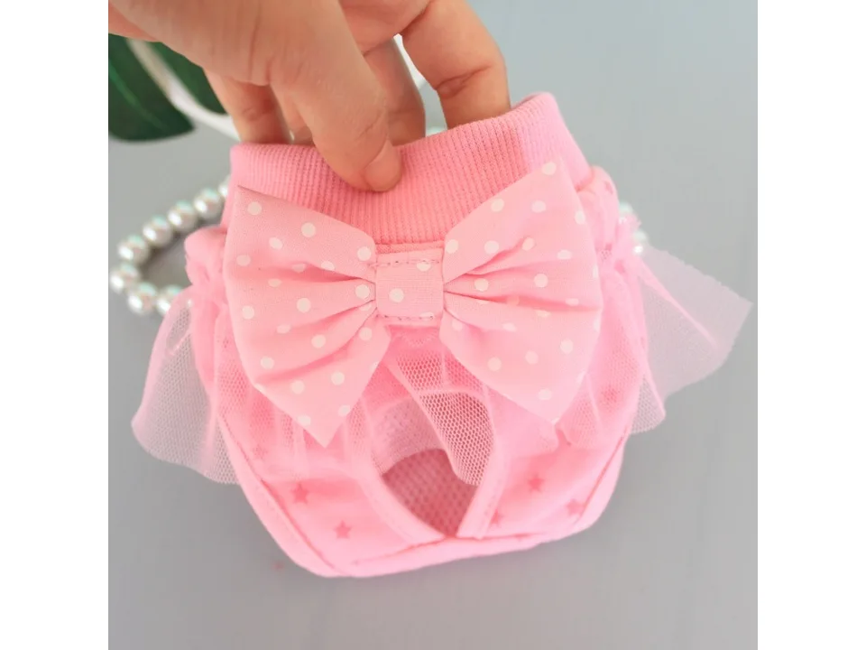 Pink dog menstrual pants with a polka dot bow and tulle trim.
