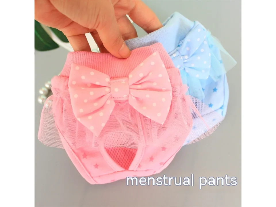 Pink dog menstrual pants with a bow and tulle trim.