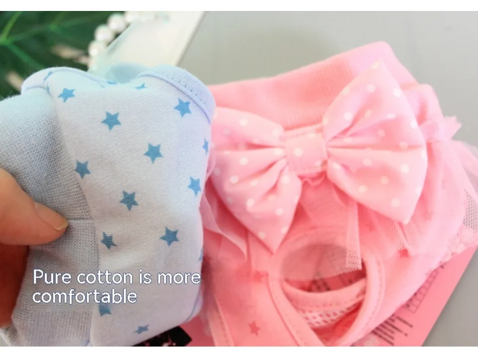 Close-up of blue and pink dog menstrual pants showing the cotton fabric and star pattern.