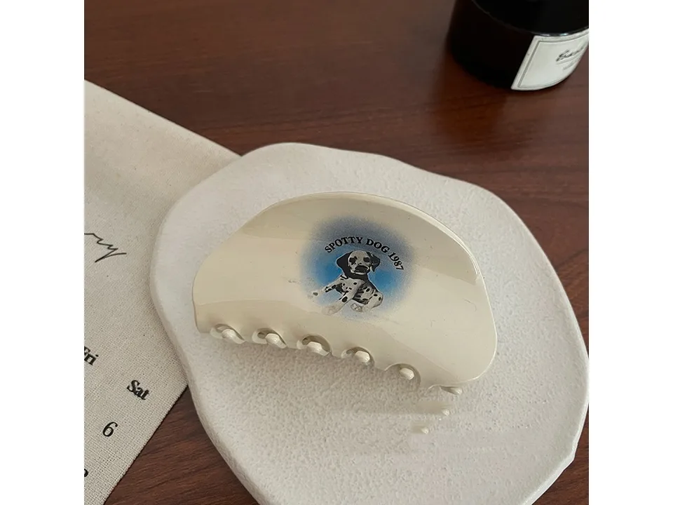 Cream hair claw clip with a dalmatian dog graphic.