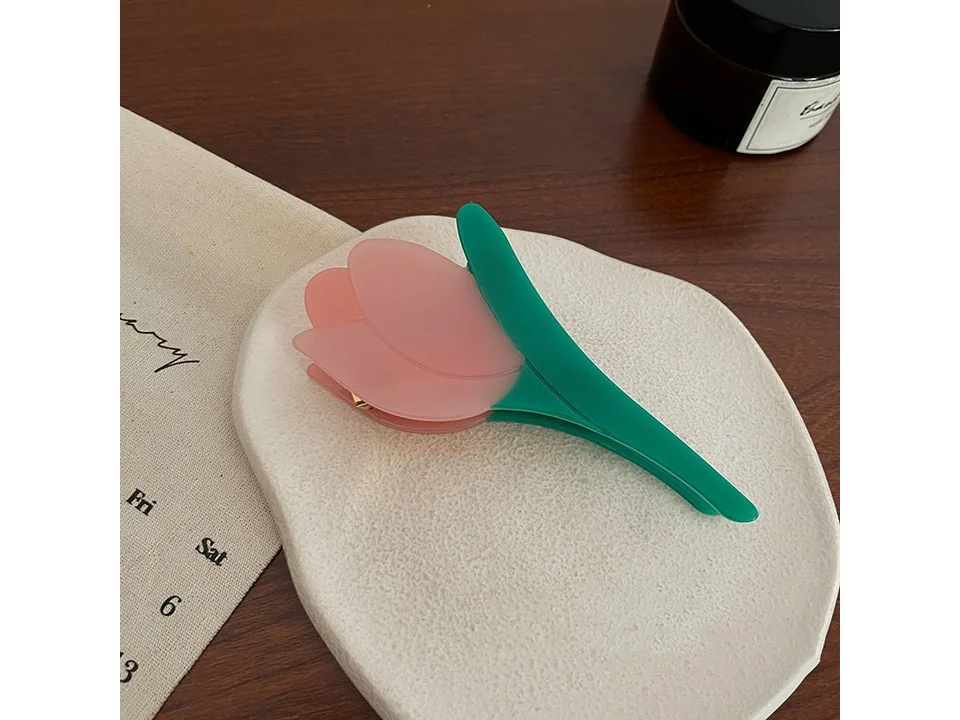 Pink and green tulip-shaped hair claw clip.