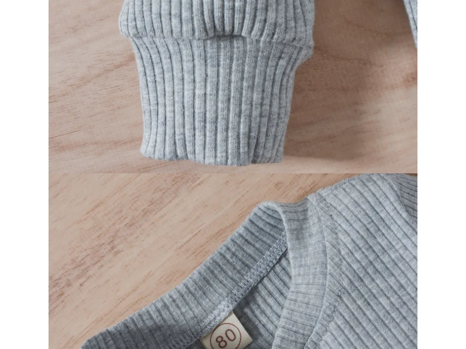 Close-up of the ribbed sleeve cuff and the neck label showing size 80.