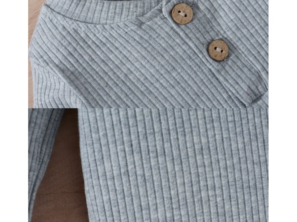 Close-up of the button-up neckline and ribbed fabric of the long-sleeve top.