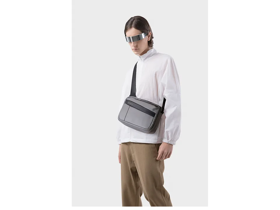 Model wearing a grey Bange crossbody bag