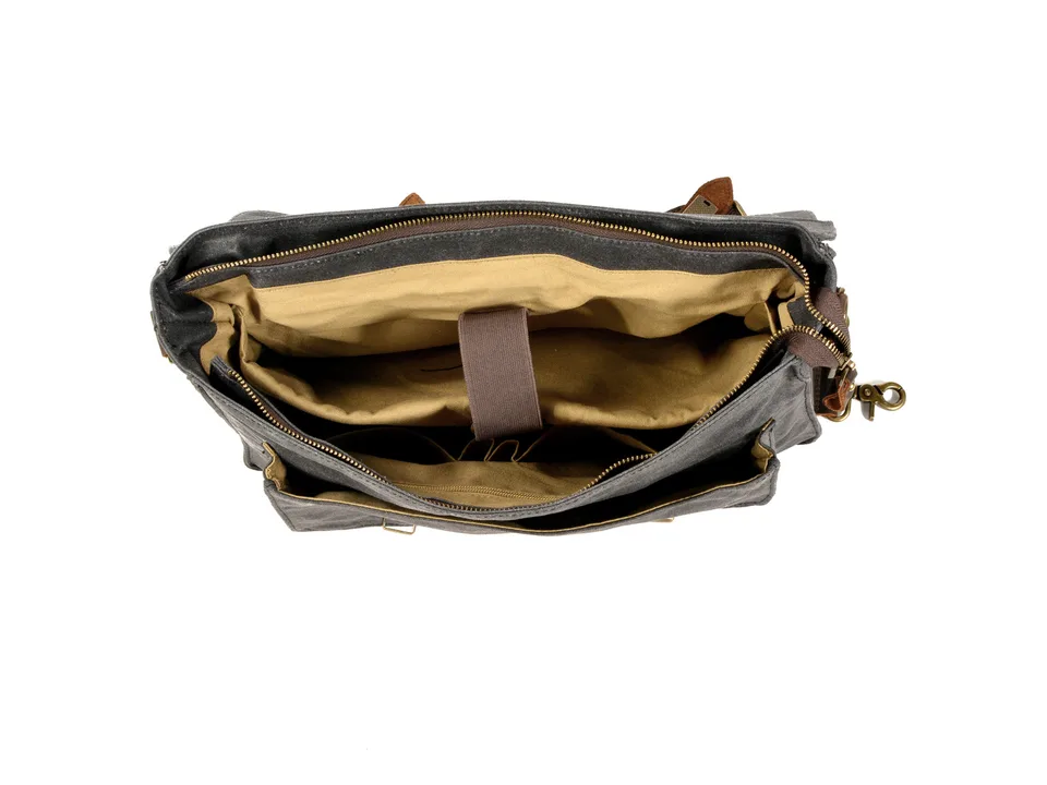 Top-down view of the open messenger bag showing the interior laptop compartment and pockets.