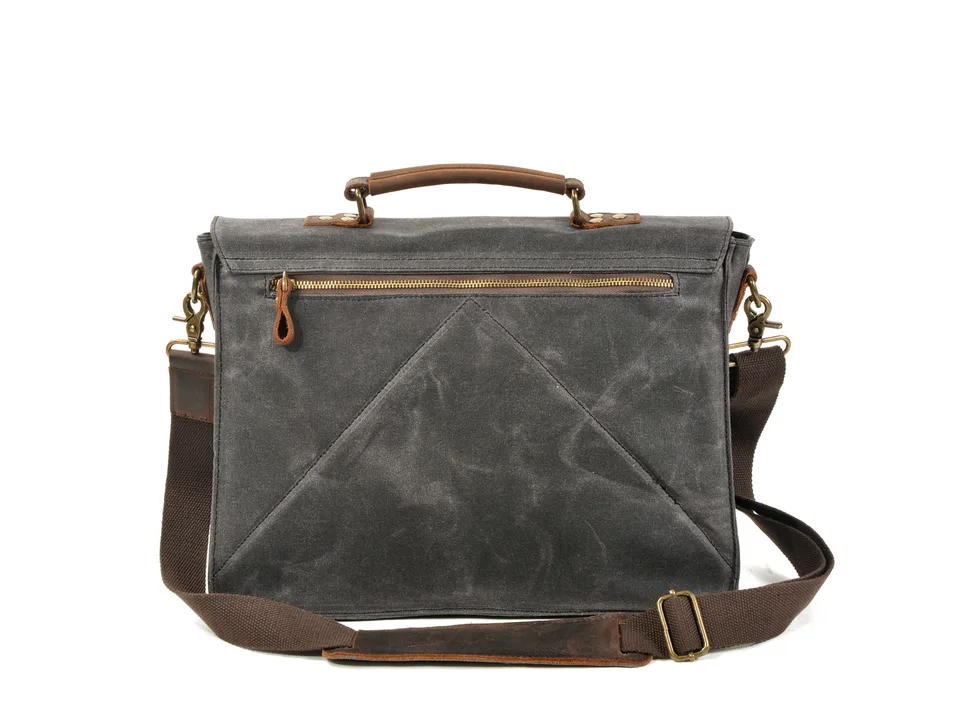 Back view of a grey canvas messenger bag showing the zipper pocket and shoulder strap.