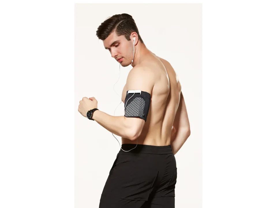 A man wearing a black mobile phone armband on his upper arm while running.