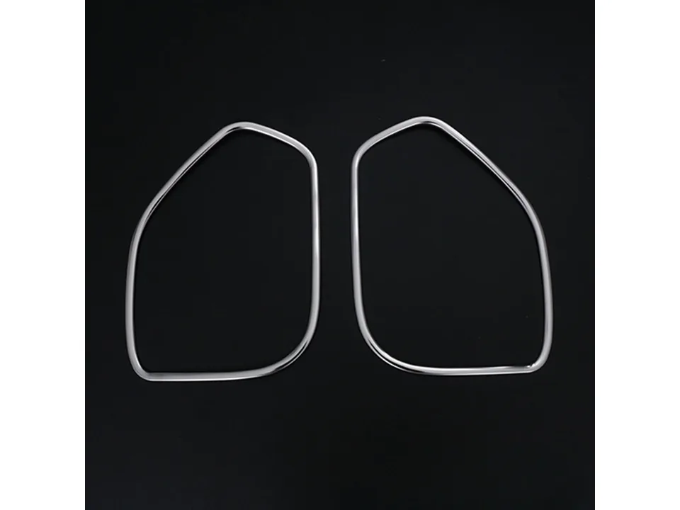 Two chrome speaker frame trim pieces on a black background.