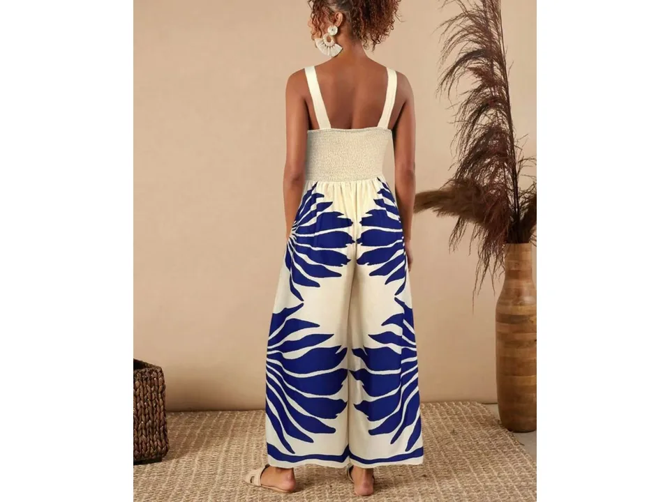Back view of a model wearing a blue and white printed wide-leg jumpsuit.