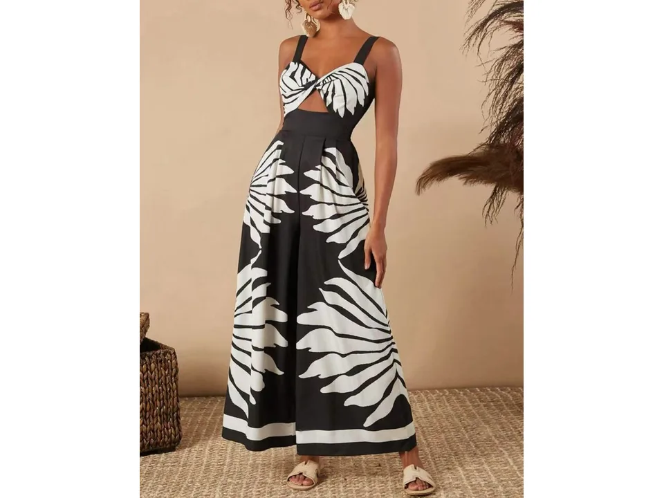 A model wearing a black and white printed sleeveless wide-leg jumpsuit with a cutout detail.