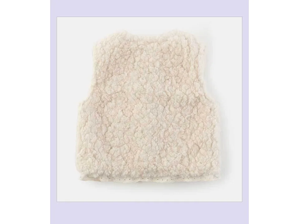 The back view of the fluffy off-white wool vest.