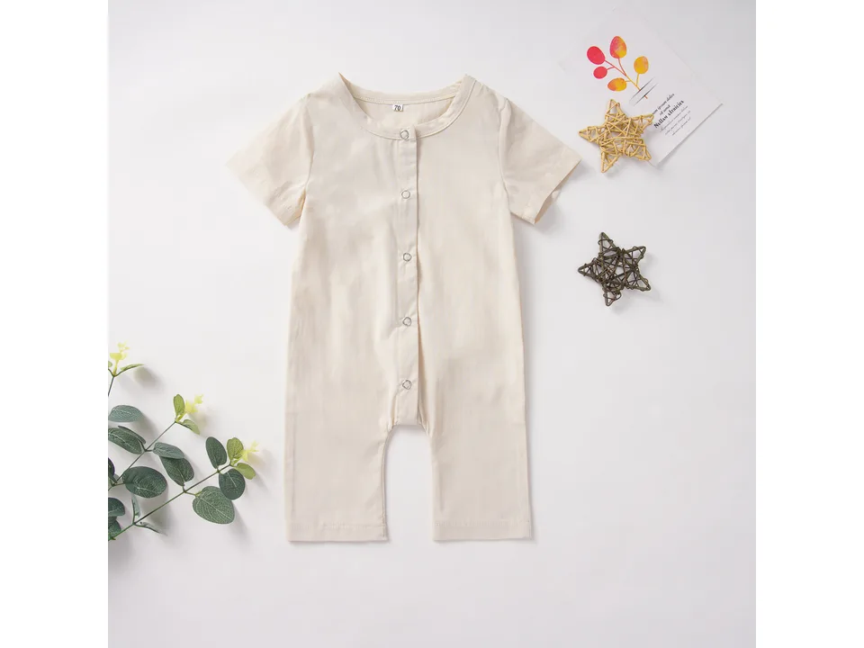 Cream colored baby romper with short sleeves and front buttons.