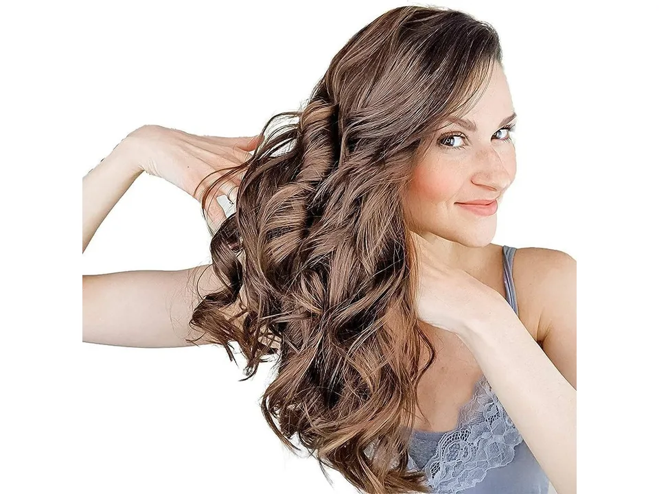 A woman showing off her finished heatless curls.